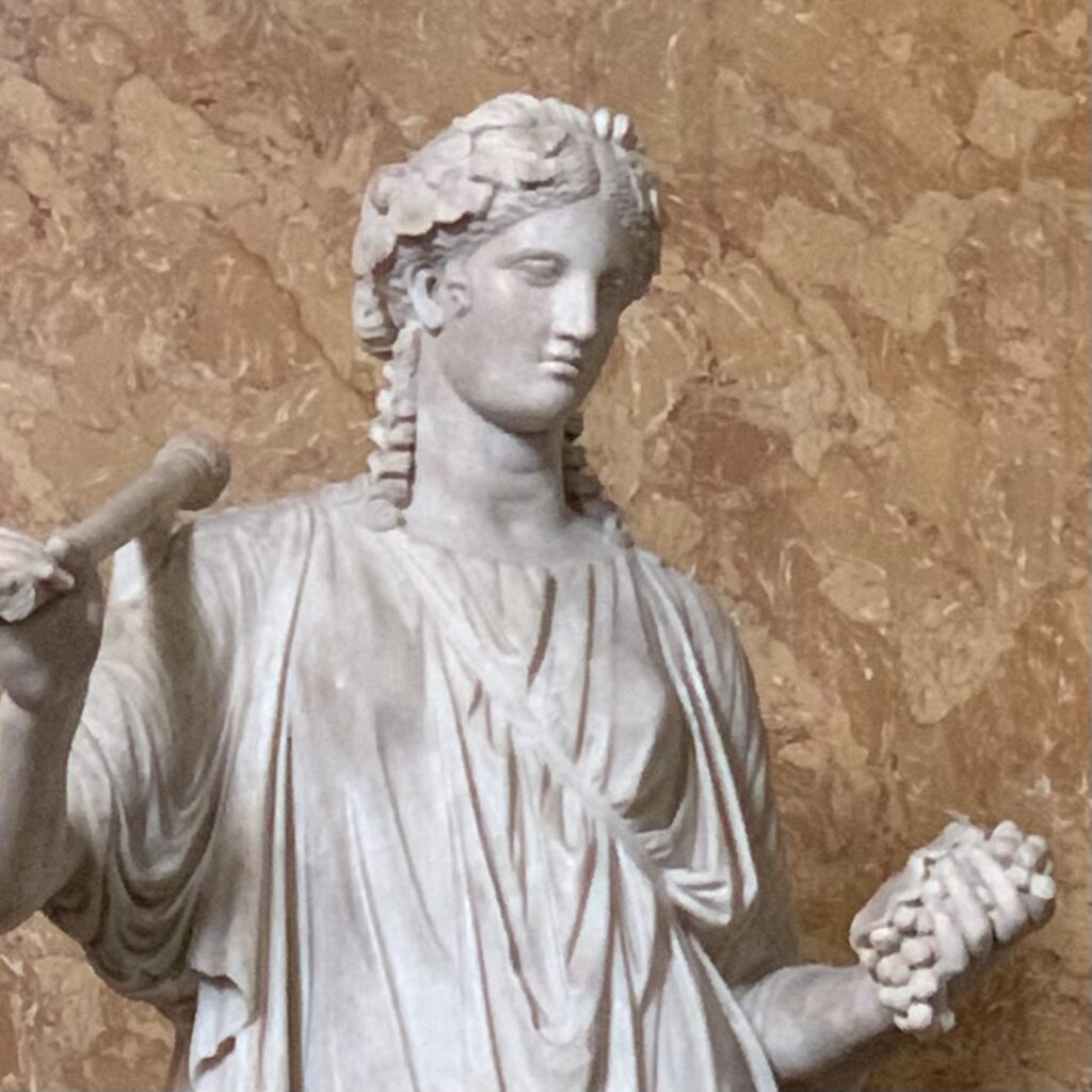 Marble sculpture of Ariadne holding a bunch of grapes.