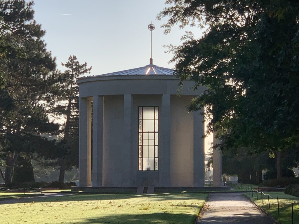 A small chapel with round walls and tall narrow windows.